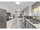 Modern kitchen featuring white cabinets, stainless steel appliances, granite countertops and stylish backsplash at 4051 S Cherokee St, Englewood, CO 80110