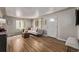 Inviting living room features hardwood floors, a comfortable white sofa, and a bright entry door at 4051 S Cherokee St, Englewood, CO 80110