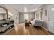 Open-concept living room with hardwood floors, a white sofa, and stylish decor, flowing into other spaces at 4051 S Cherokee St, Englewood, CO 80110