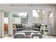 Bright living room with large windows and cozy seating area at 4051 S Cherokee St, Englewood, CO 80110