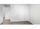 Bright bedroom with new wood-look flooring and a double closet with white doors at 4787 Carr St, Wheat Ridge, CO 80033
