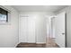 Cozy bedroom with neutral walls, wood-look floors, and a double-door closet for ample storage at 4787 Carr St, Wheat Ridge, CO 80033