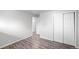 This bedroom features wood-look floors and a double closet with white doors at 4787 Carr St, Wheat Ridge, CO 80033