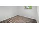 Clean bedroom featuring wood-look floors, a window providing natural light, and freshly painted walls at 4787 Carr St, Wheat Ridge, CO 80033