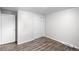 This bedroom features wood-look floors and white closet and passage doors at 4787 Carr St, Wheat Ridge, CO 80033
