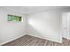 Bedroom with new wood-look flooring, large window, and fresh paint at 4787 Carr St, Wheat Ridge, CO 80033