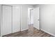 Bright bedroom with new wood-look flooring and a double closet with white doors at 4787 Carr St, Wheat Ridge, CO 80033