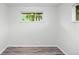 Bedroom with new wood-look flooring, a window, and neutral colored walls at 4787 Carr St, Wheat Ridge, CO 80033