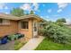 Charming home exterior with brick facade, walkway, and garden bed with bright blue pots leading to the front door at 4787 Carr St, Wheat Ridge, CO 80033