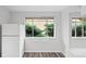 Bright kitchenette area showcasing wood-look floors, freshly painted walls, and a large window at 4787 Carr St, Wheat Ridge, CO 80033