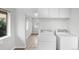Practical laundry area equipped with modern washer and dryer units and ample storage at 4787 Carr St, Wheat Ridge, CO 80033