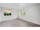 Neutral living room with wood-look floors, freshly painted walls, and a door and windows providing natural light at 4787 Carr St, Wheat Ridge, CO 80033