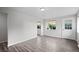 Inviting living room with wood-look floors, fresh paint, and large window overlooking the front yard at 4787 Carr St, Wheat Ridge, CO 80033