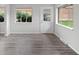 Bright living room featuring wood-look floors, large windows, and a glass-paneled door at 4787 Carr St, Wheat Ridge, CO 80033