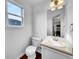 Well-lit half bathroom with a modern vanity, mirror, and fixtures at 12032 Leyden St, Brighton, CO 80602