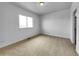 An empty, bright bedroom with carpet and a window at 12032 Leyden St, Brighton, CO 80602