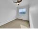 Bright bedroom features neutral carpet, a ceiling fan, and a window that lets in plenty of natural light at 12032 Leyden St, Brighton, CO 80602