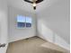 Bright bedroom features neutral carpet, a ceiling fan, and a window that lets in plenty of natural light at 12032 Leyden St, Brighton, CO 80602