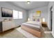 Cozy bedroom with a neutral color palette, soft lighting, and stylish furniture at 12032 Leyden St, Brighton, CO 80602