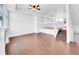 Spacious living room featuring gleaming hardwood floors and a modern ceiling fan at 12032 Leyden St, Brighton, CO 80602