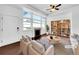 Bright living room with a fireplace, large windows, and modern furnishings at 12032 Leyden St, Brighton, CO 80602