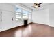 Bright living room featuring large windows and hardwood floors at 12032 Leyden St, Brighton, CO 80602