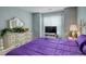 Comfortable bedroom with a large dresser, mirror, and a flat-screen TV at 19049 E Warren Dr # 105, Aurora, CO 80013