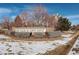 Attractive stone sign for 'The Villas at Aspen Ridge', set amidst manicured landscaping and light snowfall at 19049 E Warren Dr # 105, Aurora, CO 80013