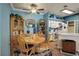 Bright dining room with a wooden table and chairs with kitchen view at 19049 E Warren Dr # 105, Aurora, CO 80013