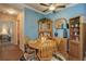 Inviting dining room with wooden table, cabinets and blue accent wall at 19049 E Warren Dr # 105, Aurora, CO 80013