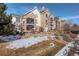 Attractive condo building showcases multiple balconies, stone details, and well-kept landscaping at 19049 E Warren Dr # 105, Aurora, CO 80013