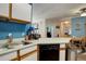Bright kitchen with white cabinets, stainless steel appliances, and open layout at 19049 E Warren Dr # 105, Aurora, CO 80013
