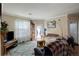 Open living room with comfortable seating, natural light, and a fireplace at 19049 E Warren Dr # 105, Aurora, CO 80013