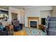 Cozy living room with fireplace, wood mantel, and blue accent rug at 19049 E Warren Dr # 105, Aurora, CO 80013