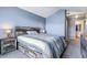Comfortable bedroom with rustic wood accents, a queen bed, and an ensuite bathroom at 9311 Amison Cir # 201, Parker, CO 80134