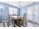 Dining area featuring a wooden table with seating for four and modern light fixture at 9311 Amison Cir # 201, Parker, CO 80134