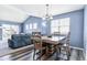 Cozy dining area adjacent to the living room with modern wood floors and stylish chandelier at 9311 Amison Cir # 201, Parker, CO 80134
