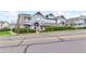 Attractive townhome featuring a blend of blue siding, brick accents, well-kept landscaping, and a street view at 9311 Amison Cir # 201, Parker, CO 80134