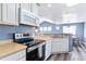 Well-lit kitchen boasting an electric range, microwave, and stylish gray wood flooring at 9311 Amison Cir # 201, Parker, CO 80134