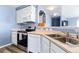 Cozy kitchen featuring modern appliances, including an electric range, microwave, and dishwasher at 9311 Amison Cir # 201, Parker, CO 80134