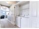 Convenient laundry room with a washer, dryer, and built-in shelving for organization at 9311 Amison Cir # 201, Parker, CO 80134