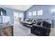 Comfortable living room with a gray sectional, fireplace, access to a balcony, and plenty of natural light at 9311 Amison Cir # 201, Parker, CO 80134