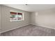 Neutral bedroom featuring a window with natural light and plush carpet, offering a serene and comfortable space at 1658 Glade Gulch Rd, Castle Rock, CO 80104