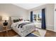 Cozy bedroom featuring a charming bed, hardwood floors, and a bright window with stylish curtains at 1658 Glade Gulch Rd, Castle Rock, CO 80104