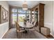 Charming dining room boasts ample natural light, a rustic table, and a decorative cabinet, perfect for Gathering gatherings at 1658 Glade Gulch Rd, Castle Rock, CO 80104