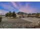 A luxurious home exterior featuring a three-car garage, a spacious driveway, and lush landscaping at 1658 Glade Gulch Rd, Castle Rock, CO 80104