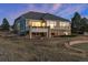 Beautiful home exterior with deck, stone accents, and manicured landscaping at 1658 Glade Gulch Rd, Castle Rock, CO 80104