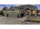Beautiful two-story home featuring a three-car garage, stone accents, and professionally landscaped front yard at 1658 Glade Gulch Rd, Castle Rock, CO 80104