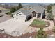 A charming home exterior featuring a three-car garage, a lush lawn, and mature trees at 1658 Glade Gulch Rd, Castle Rock, CO 80104