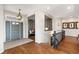 Inviting foyer featuring hardwood floors, a stylish light fixture, and elegant architectural details at 1658 Glade Gulch Rd, Castle Rock, CO 80104
